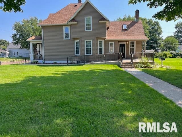 rear view of house with a yard