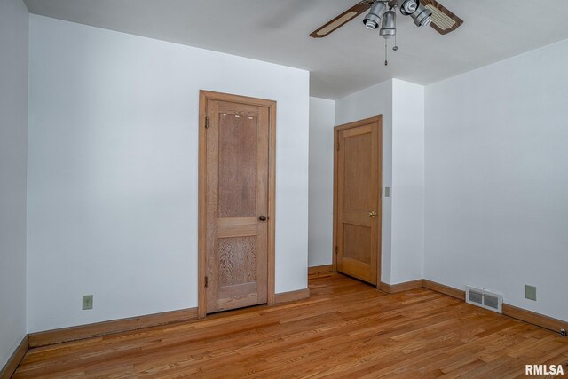 spare room featuring a wealth of natural light, ceiling fan, and dark hardwood / wood-style flooring