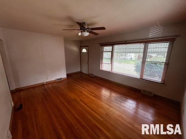 empty room featuring ceiling fan and dark hardwood / wood-style flooring