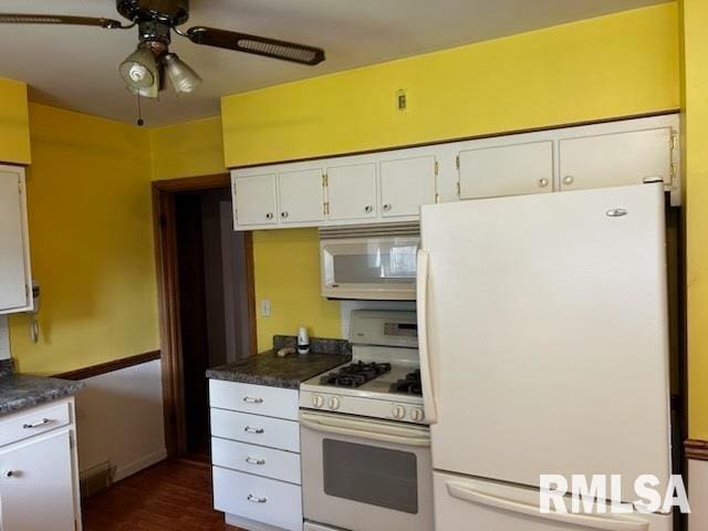 kitchen featuring white appliances, dark hardwood / wood-style flooring, white cabinetry, and ceiling fan