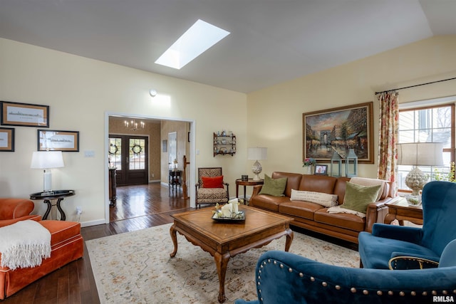 living room featuring french doors, dark hardwood / wood-style floors, and lofted ceiling with skylight