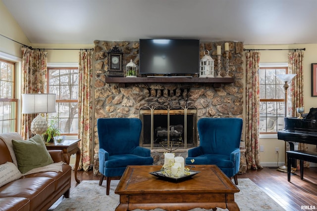 living room with a fireplace, lofted ceiling, and hardwood / wood-style floors