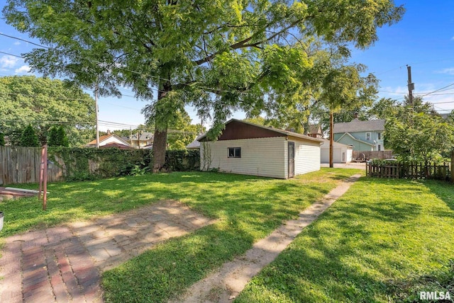 view of yard featuring an outdoor structure and a fenced backyard