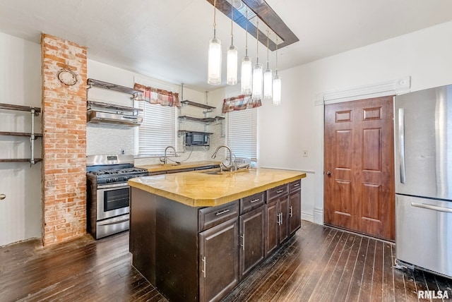 kitchen with open shelves, butcher block countertops, appliances with stainless steel finishes, dark wood-style floors, and a sink