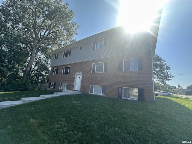 view of front of property with a front yard and brick siding