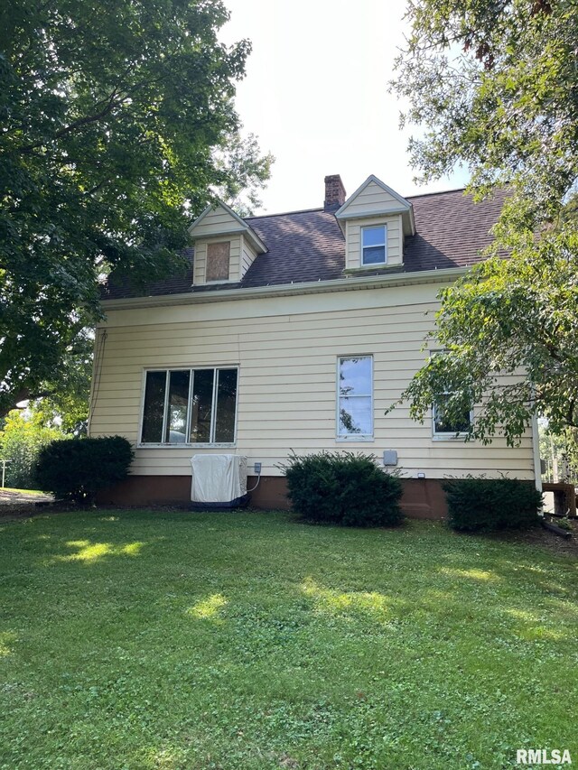 view of side of property with a yard