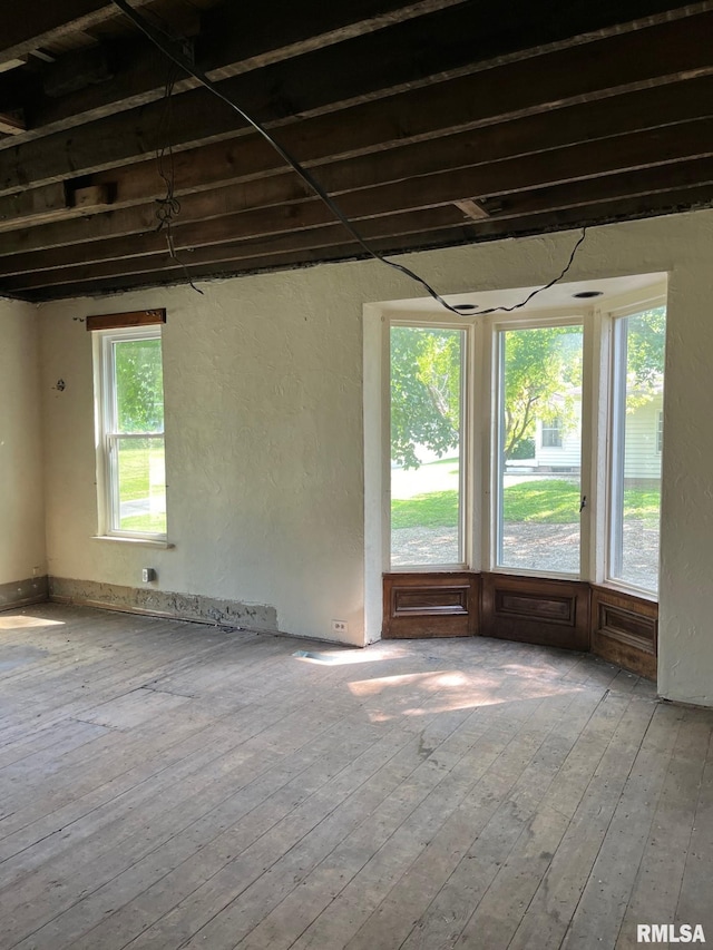 unfurnished room featuring hardwood / wood-style flooring