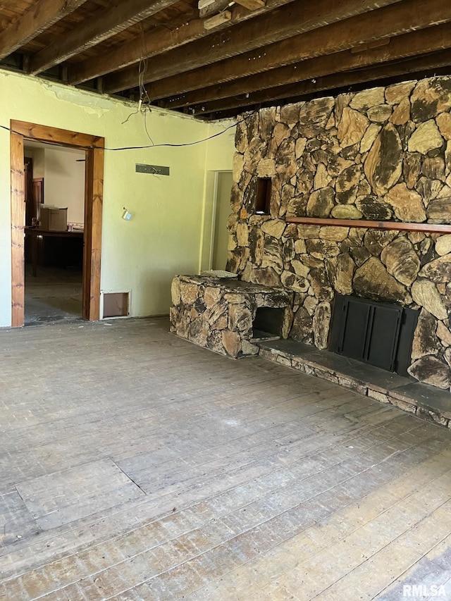 unfurnished living room featuring a fireplace and hardwood / wood-style flooring