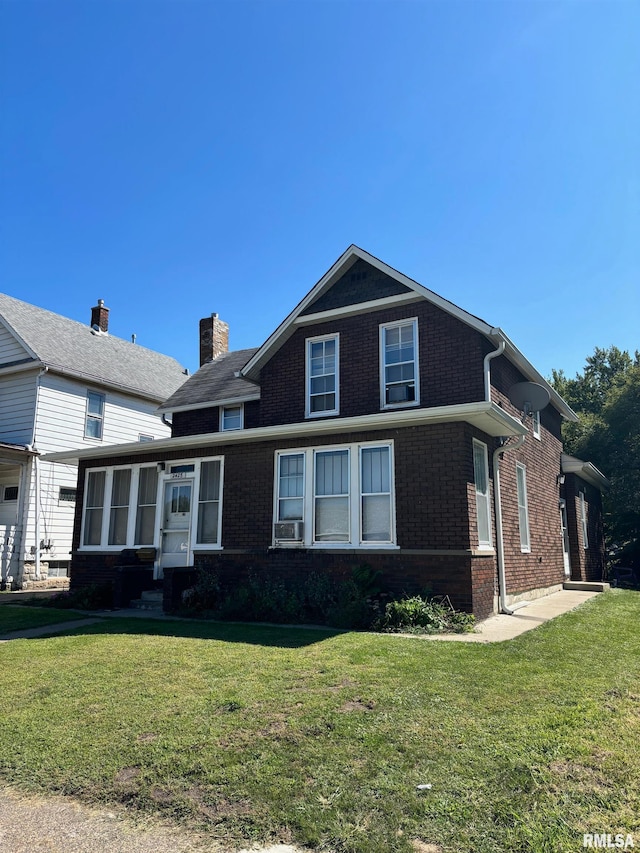 view of front of house with a front lawn and cooling unit