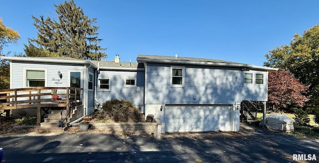 view of front facade featuring a garage and a deck