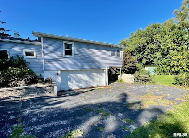 rear view of house featuring a garage