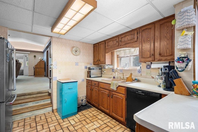 kitchen with stainless steel fridge, dishwasher, sink, and a drop ceiling