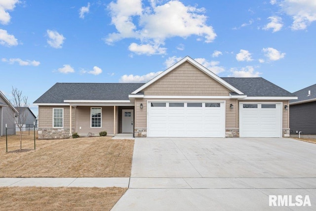 view of front facade with a garage and a front lawn