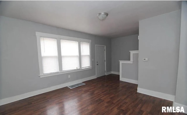 spare room featuring dark hardwood / wood-style floors