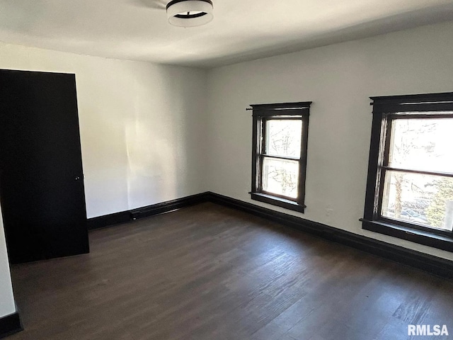 empty room featuring dark wood-type flooring