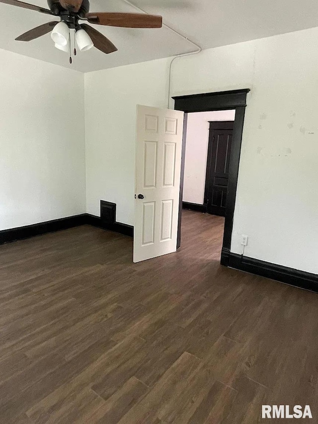 spare room with ceiling fan and dark hardwood / wood-style floors