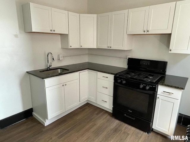 kitchen with dark hardwood / wood-style flooring, sink, black gas range, and white cabinets