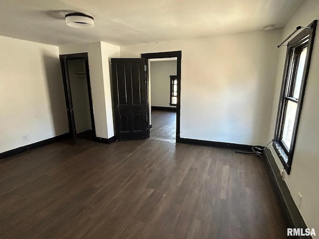 unfurnished room featuring dark wood-type flooring