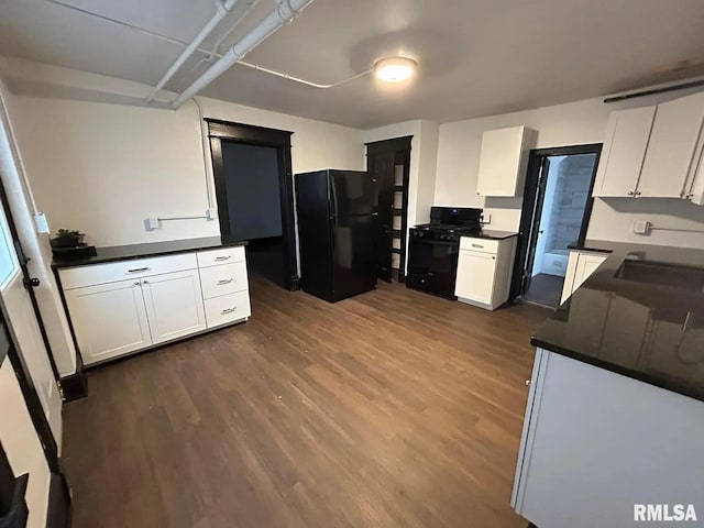 kitchen featuring black appliances, dark hardwood / wood-style flooring, and white cabinets