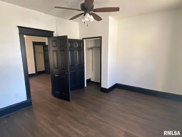 unfurnished bedroom featuring a textured ceiling, ceiling fan, and dark hardwood / wood-style floors