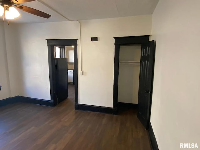 unfurnished bedroom with dark wood-type flooring and ceiling fan