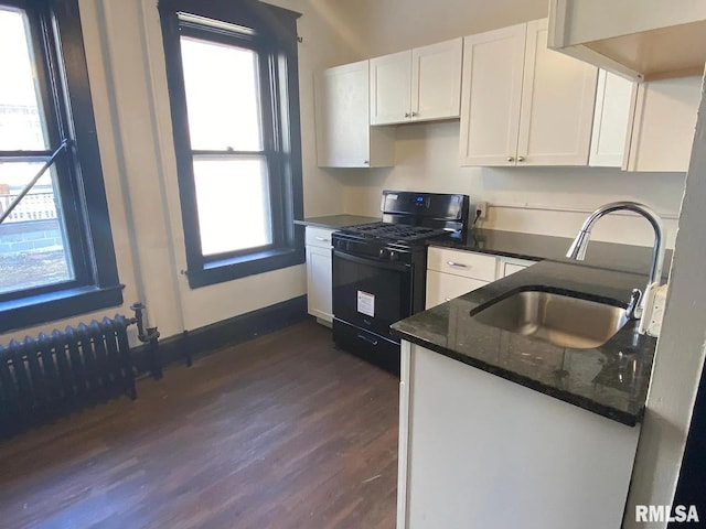 kitchen with a wealth of natural light, white cabinetry, sink, and gas stove