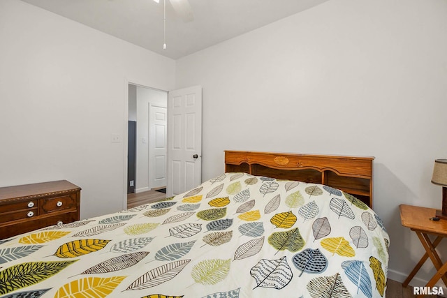 bedroom with hardwood / wood-style floors and ceiling fan