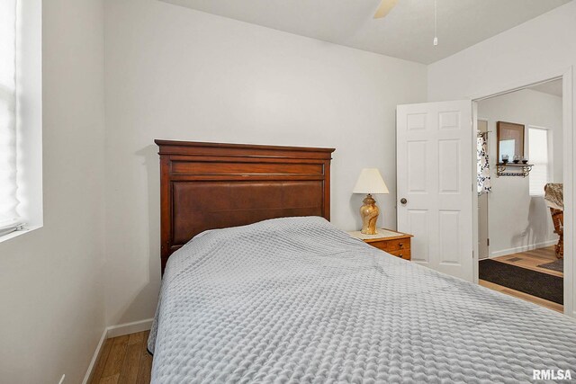 bedroom with ceiling fan and hardwood / wood-style floors