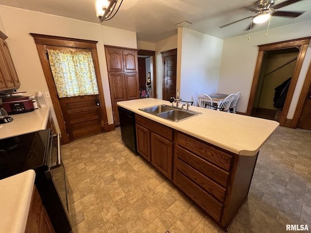 kitchen featuring stainless steel electric range, dishwasher, sink, an island with sink, and ceiling fan