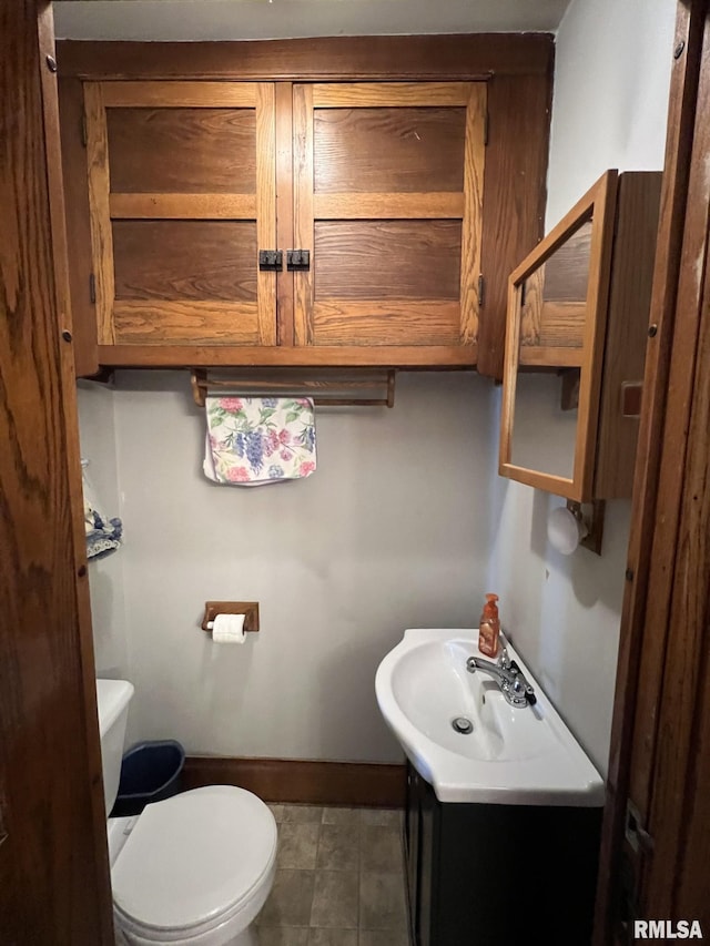 bathroom with vanity, toilet, and tile patterned floors