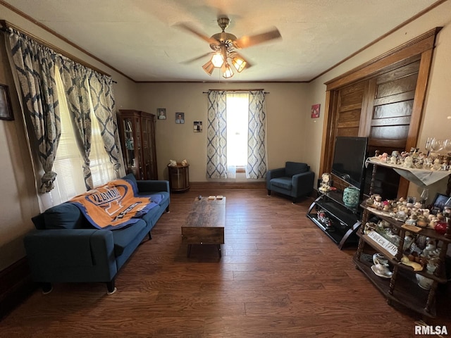 living room with crown molding, dark wood-type flooring, and ceiling fan