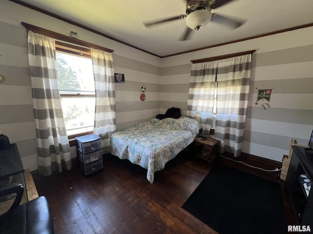 bedroom featuring ornamental molding, dark hardwood / wood-style flooring, and ceiling fan