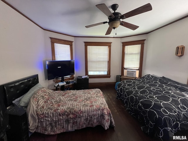 bedroom with multiple windows, ceiling fan, crown molding, and wood-type flooring