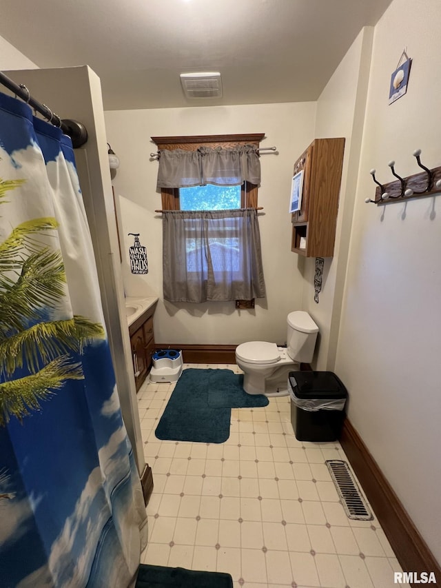 bathroom featuring vanity, toilet, and a shower with curtain