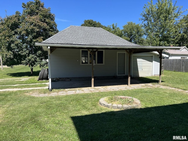 back of property featuring a yard