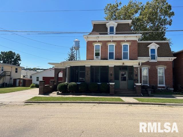 second empire-style home with brick siding