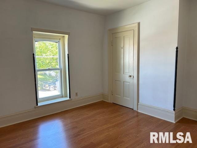 empty room featuring baseboards and wood finished floors