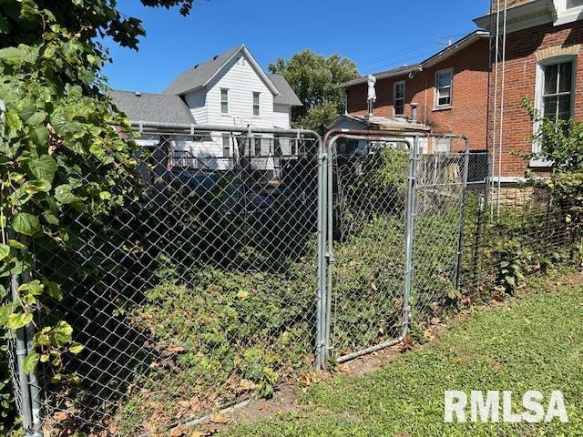 view of gate with fence