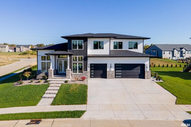 view of front facade with a garage and a front lawn