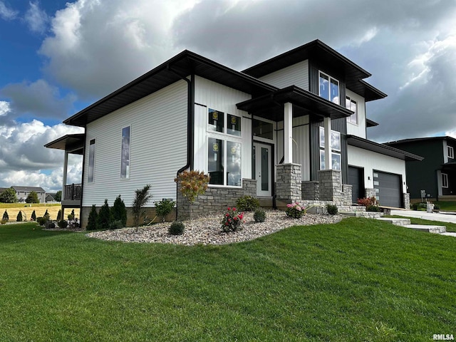 view of front of home with a front yard and a garage