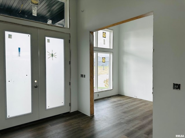 foyer featuring dark hardwood / wood-style floors and french doors