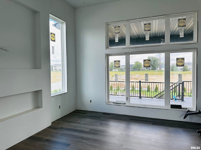 unfurnished room with dark wood-type flooring