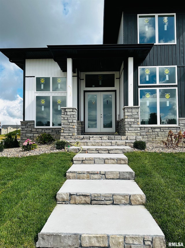 doorway to property featuring french doors and a yard