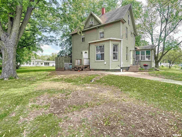 rear view of house with a lawn