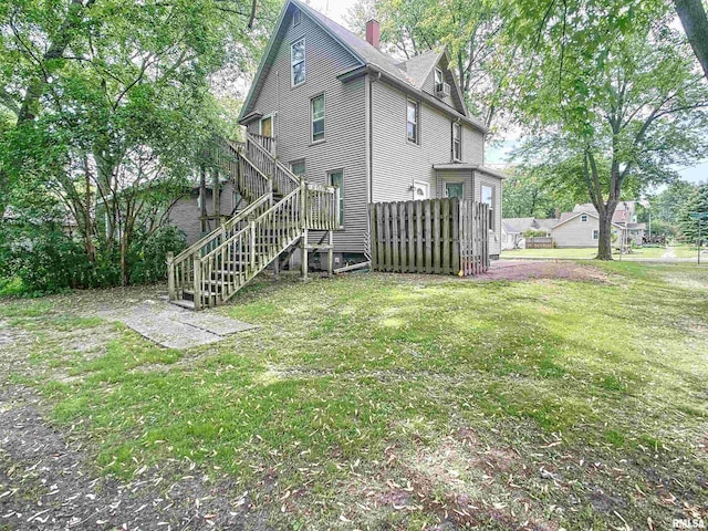 rear view of property with a lawn