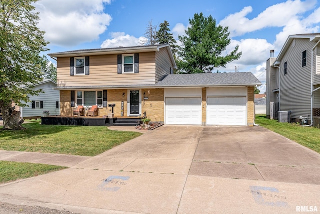 view of front of home with central AC, a front lawn, and a garage