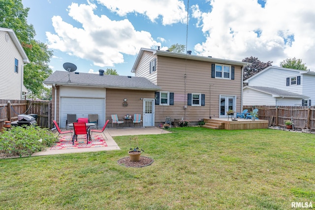 rear view of property with french doors, a lawn, a patio area, a garage, and a fenced backyard