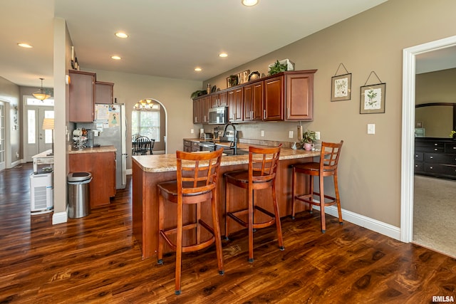 kitchen with a healthy amount of sunlight, kitchen peninsula, and stainless steel appliances