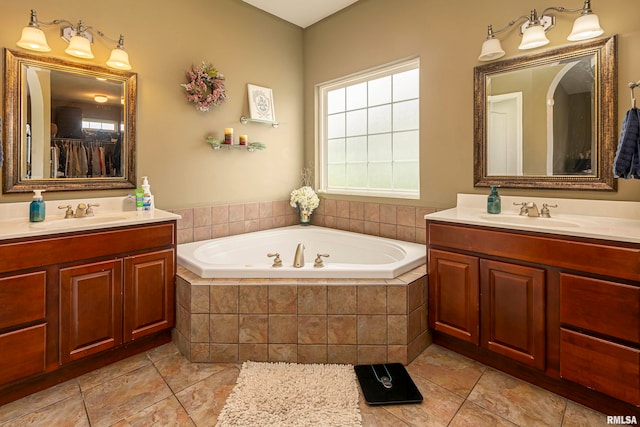 bathroom with vanity and tiled bath