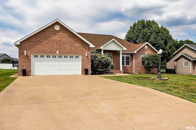 single story home with a front yard and a garage